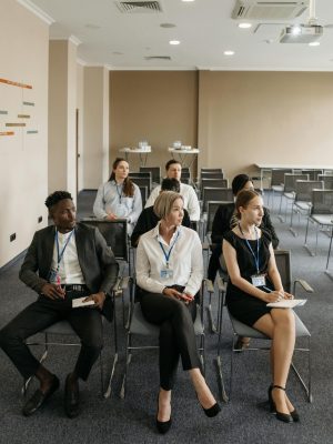 Group of professionals attentively sitting in a modern conference room setting.